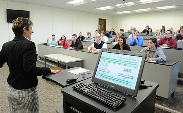 Photo of professor in front of students at a lecture