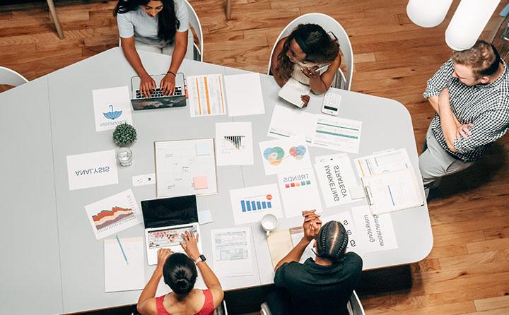 Professionals sitting around table strategic marketing